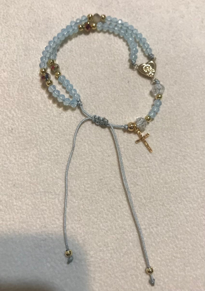 Pulsera Rosario celeste.